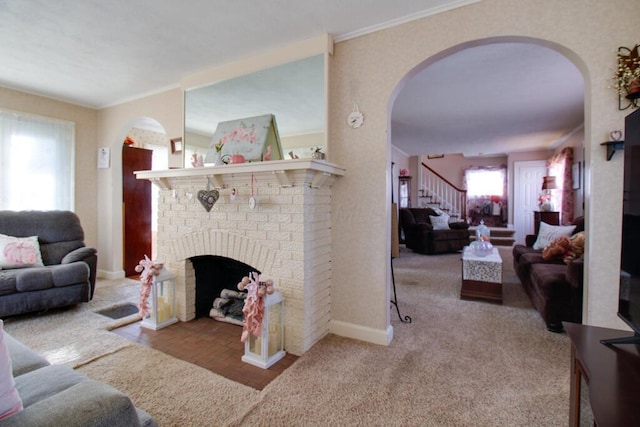 living room with a fireplace, light colored carpet, and crown molding