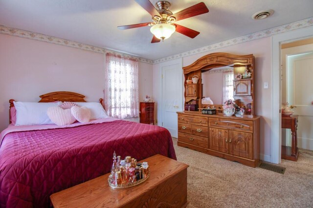 bedroom featuring ceiling fan and light carpet