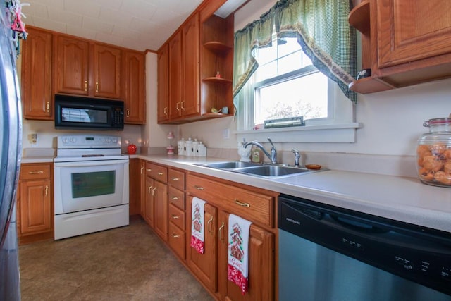 kitchen with stainless steel dishwasher, electric stove, and sink