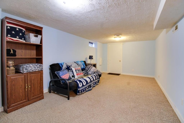 sitting room with light carpet and a textured ceiling