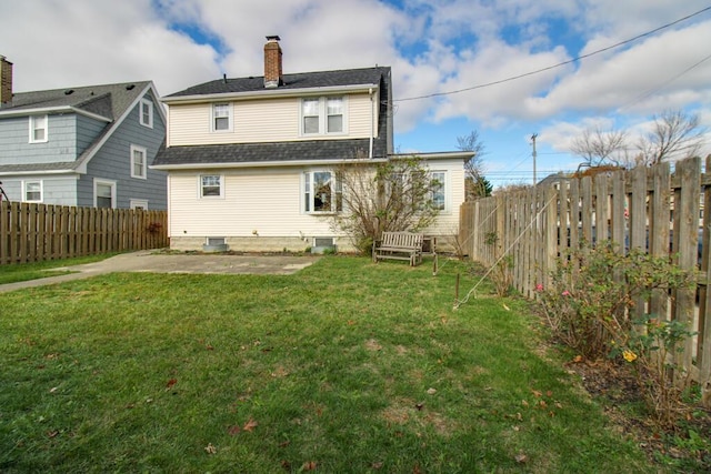 back of house with a yard and a patio