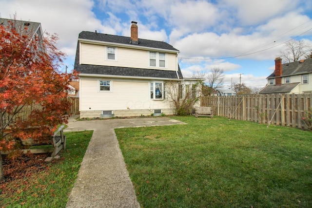 back of property with a patio area and a yard