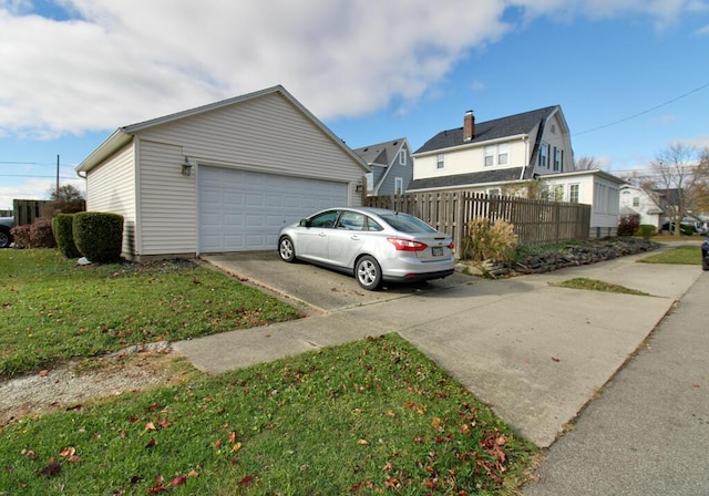 view of home's exterior with a garage and a lawn