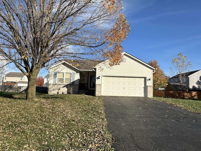 view of front of home featuring a garage and a front lawn