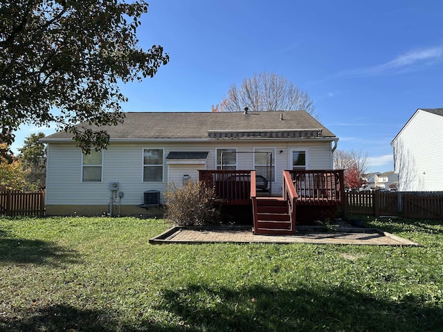 rear view of house featuring central AC unit, a lawn, and a wooden deck