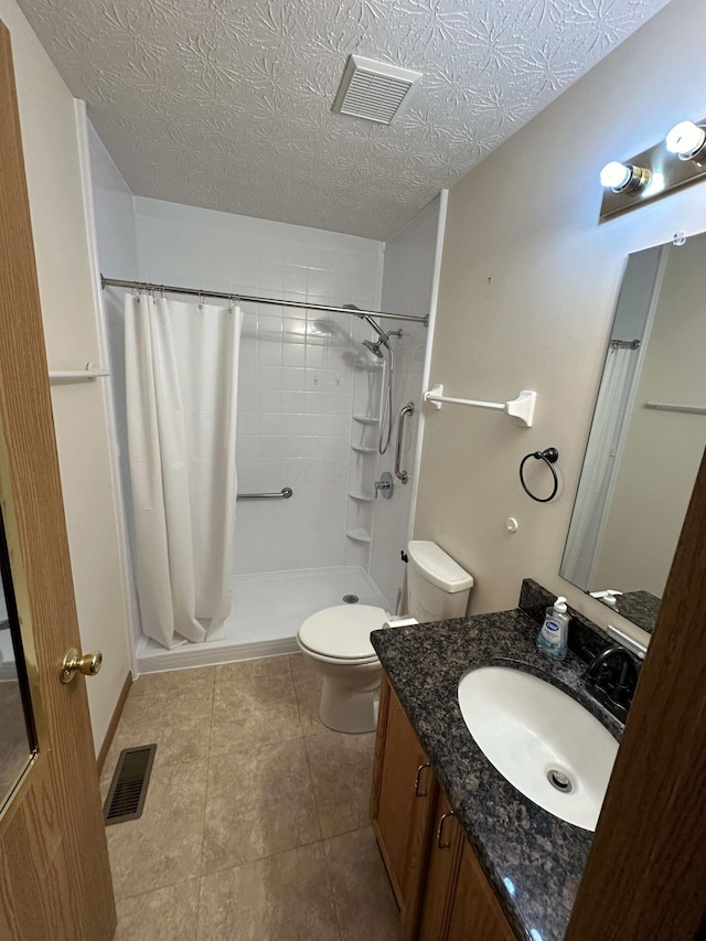 bathroom featuring walk in shower, vanity, a textured ceiling, and toilet