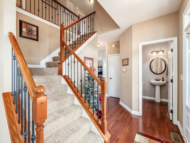 staircase featuring hardwood / wood-style flooring