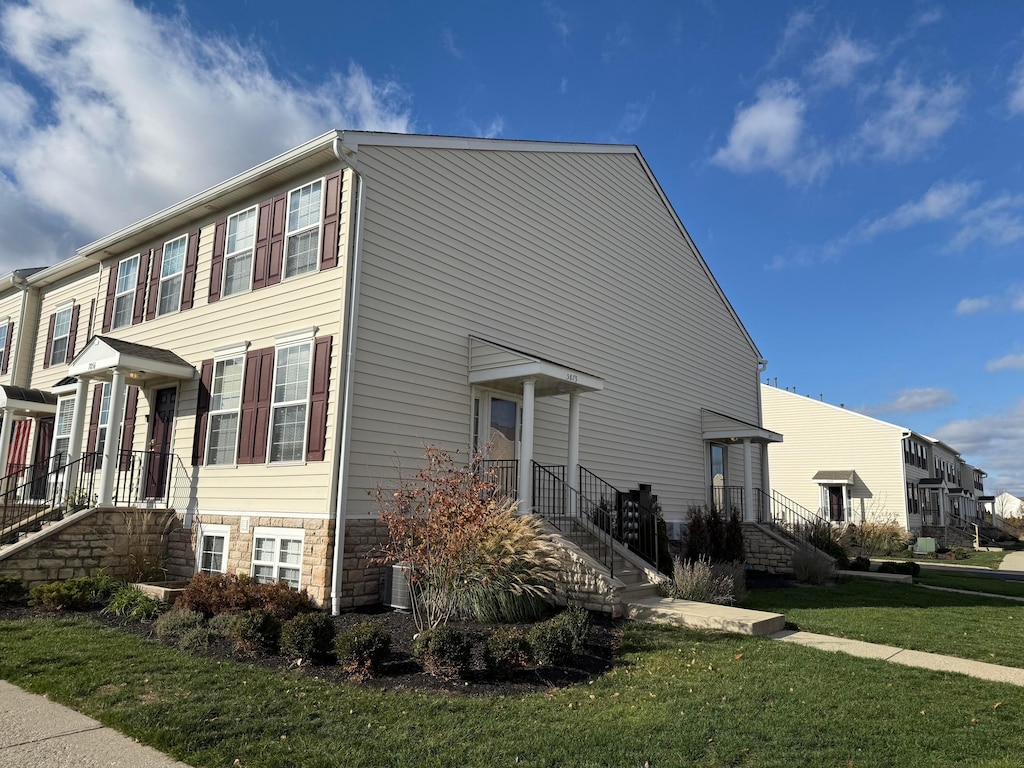 view of home's exterior featuring a yard and central AC unit