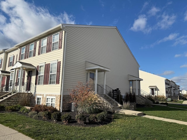 view of home's exterior featuring a yard and central AC unit