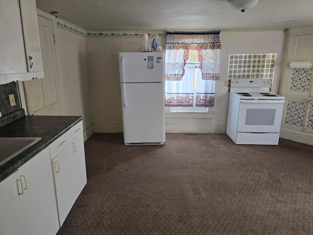 kitchen featuring dark colored carpet, white cabinetry, white appliances, and sink