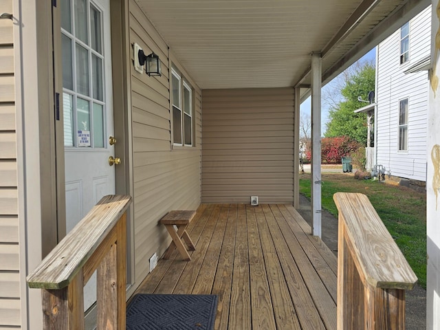 wooden terrace featuring covered porch