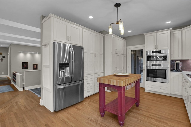 kitchen featuring decorative backsplash, stainless steel appliances, white cabinets, and light wood-type flooring