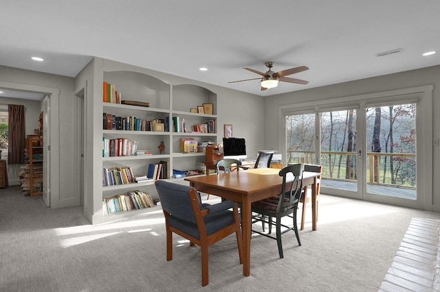 carpeted dining room featuring built in features and ceiling fan