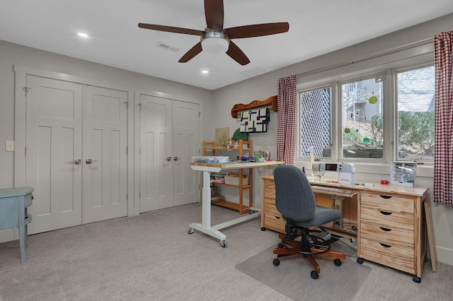 office space with ceiling fan and light carpet