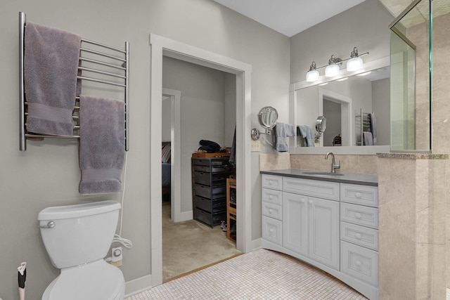 bathroom with tile patterned flooring, vanity, a shower, and toilet