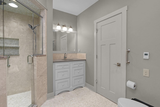 bathroom featuring tile patterned flooring, vanity, an enclosed shower, and toilet