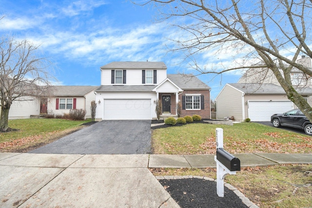 view of property featuring a garage and a front lawn