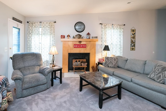 carpeted living room with a fireplace