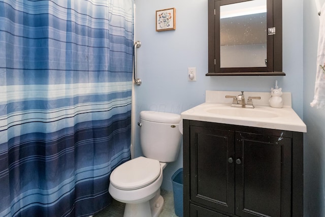 bathroom featuring tile patterned floors, vanity, toilet, and walk in shower