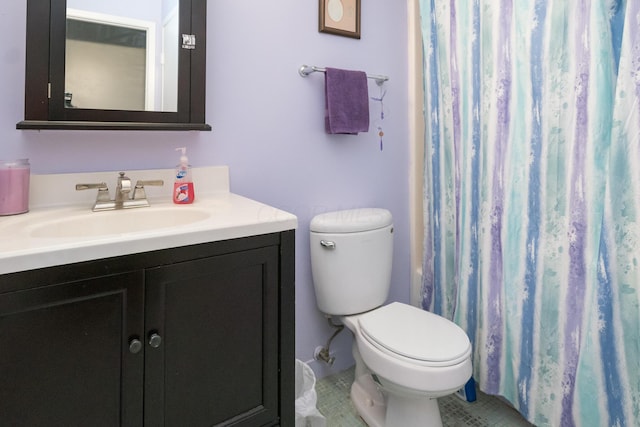 bathroom with tile patterned floors, walk in shower, vanity, and toilet