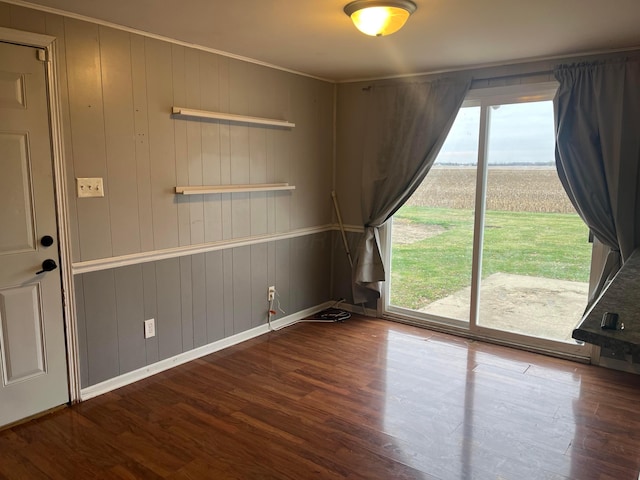 spare room with wood walls and hardwood / wood-style floors