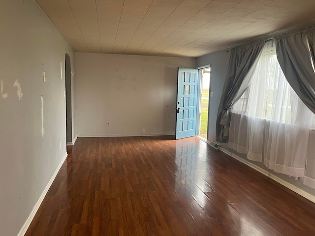 spare room featuring dark hardwood / wood-style floors