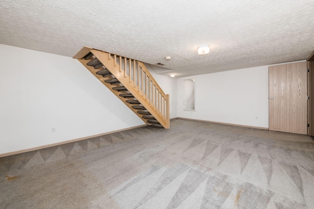 basement with a textured ceiling and carpet floors