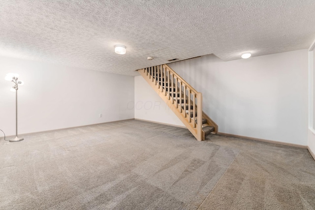 basement with carpet and a textured ceiling