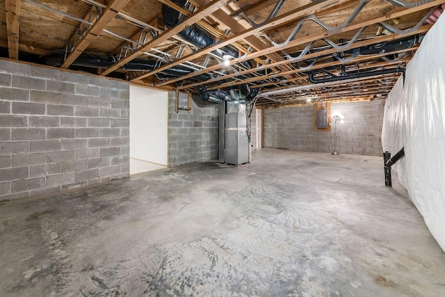 basement with electric panel and heating unit