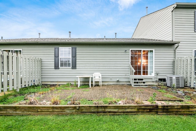 back of property with central AC unit and a patio area