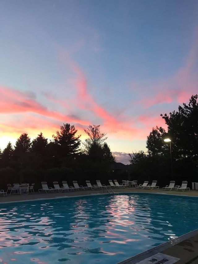 view of pool at dusk