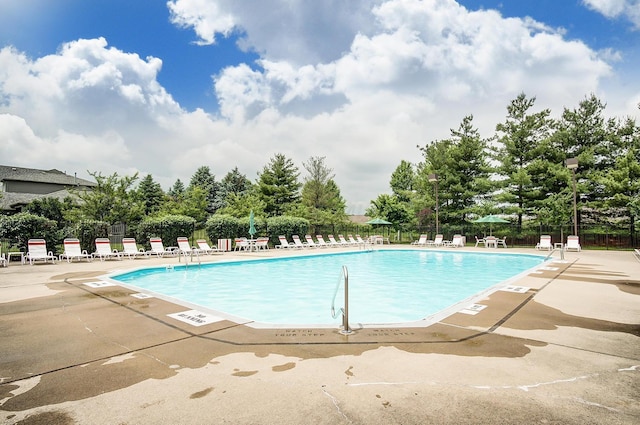 view of swimming pool featuring a patio area