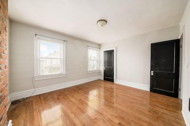 spare room with hardwood / wood-style floors