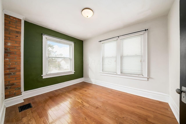 empty room featuring wood-type flooring