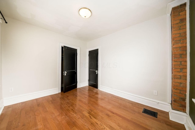 unfurnished room featuring wood-type flooring