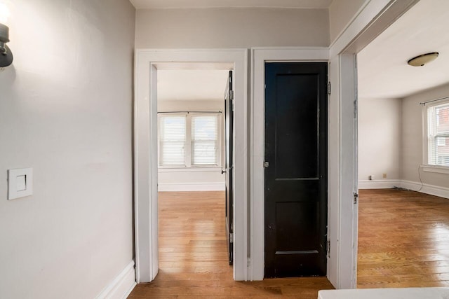 corridor with light hardwood / wood-style floors