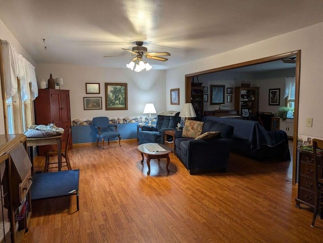 living room featuring ceiling fan and wood-type flooring