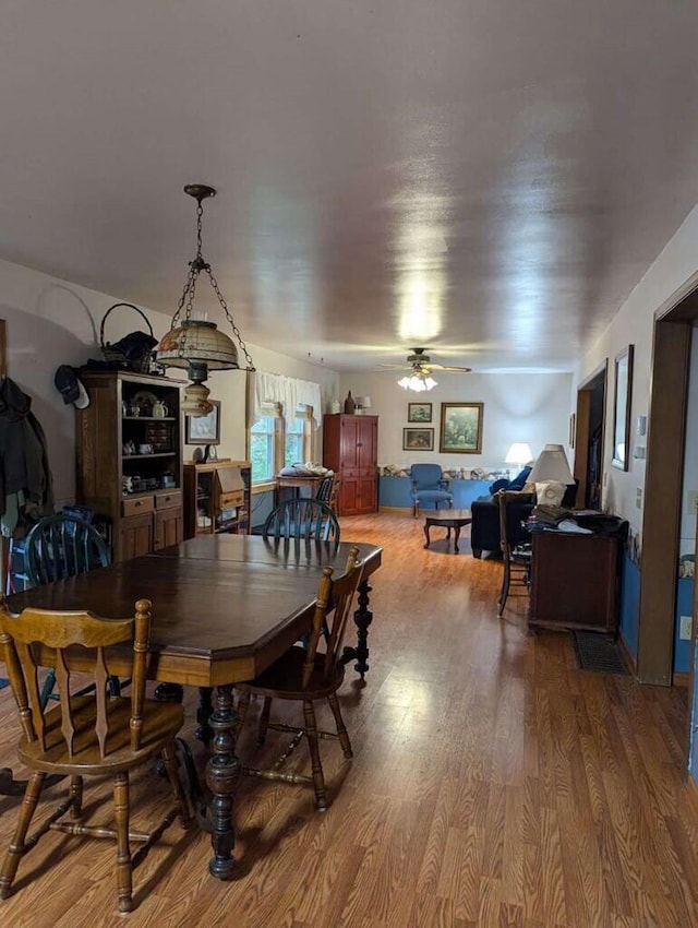 dining room with ceiling fan and wood-type flooring