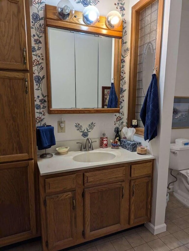 bathroom featuring tile patterned flooring, vanity, and toilet