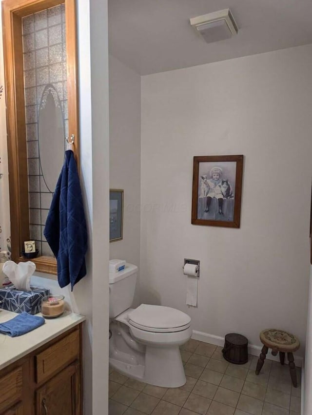 bathroom featuring tile patterned floors, vanity, and toilet