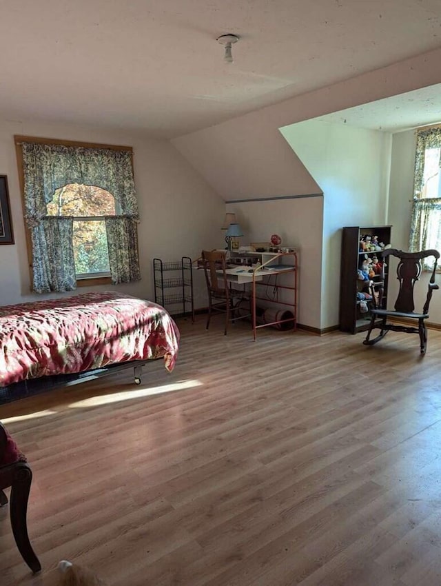 bedroom featuring hardwood / wood-style flooring and vaulted ceiling