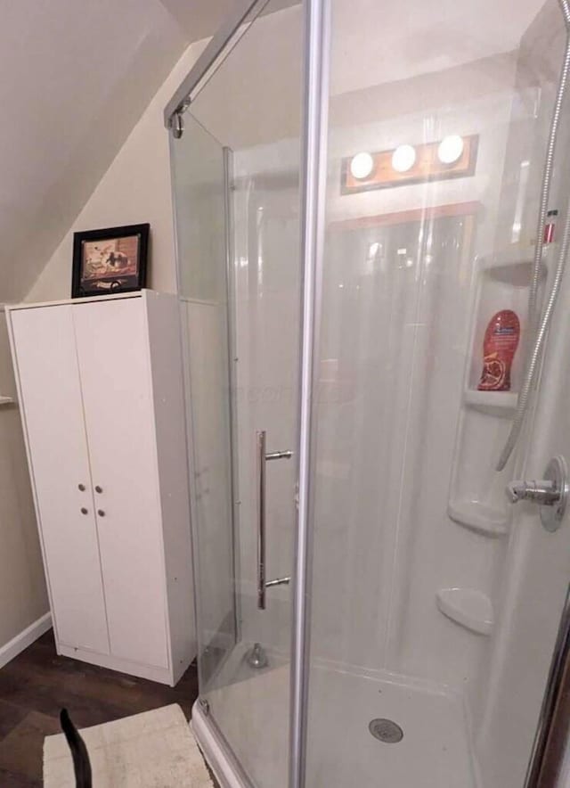 bathroom with wood-type flooring and an enclosed shower