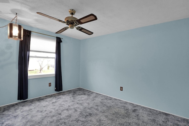 unfurnished room with a textured ceiling, carpet floors, and ceiling fan