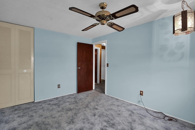 unfurnished bedroom with carpet flooring, ceiling fan, and a closet