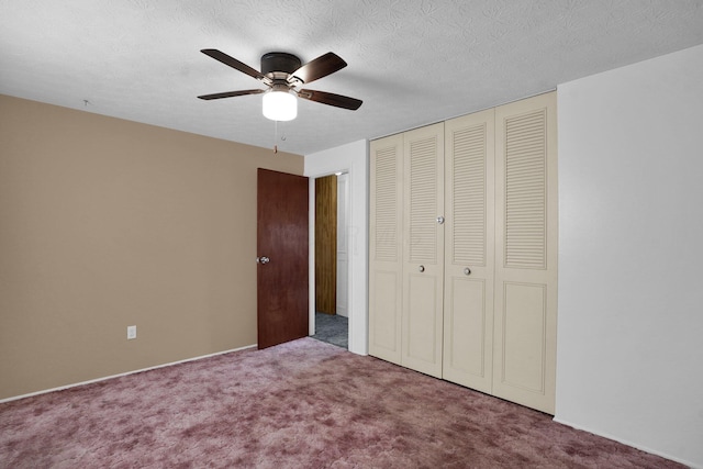 unfurnished bedroom with carpet, a textured ceiling, a closet, and ceiling fan