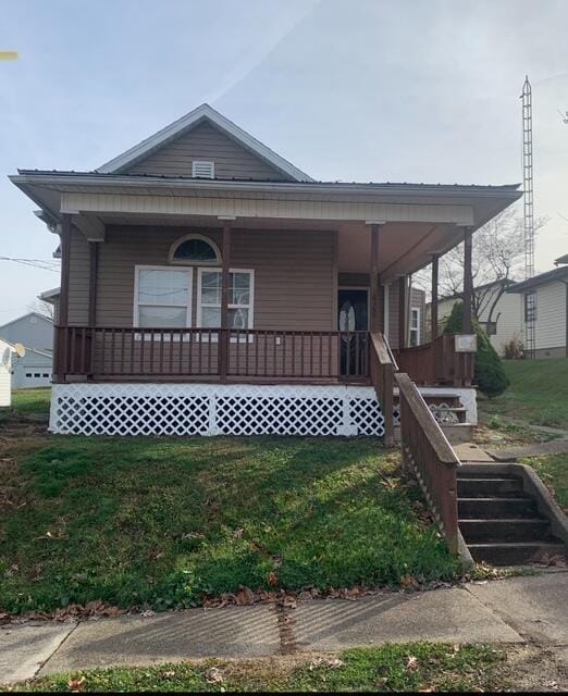 view of front of house with a porch and a front yard