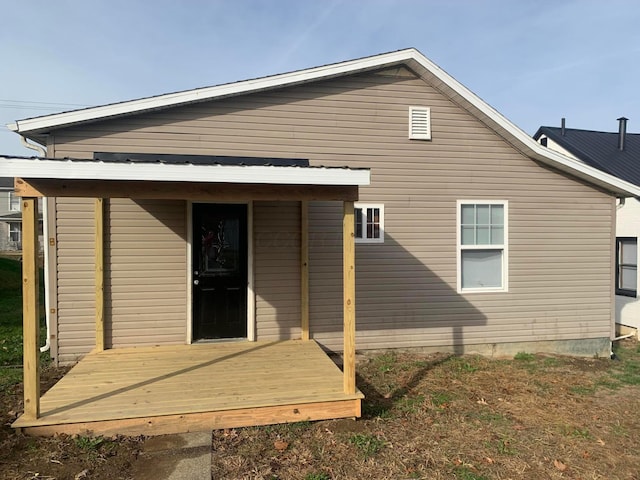 rear view of house with a wooden deck