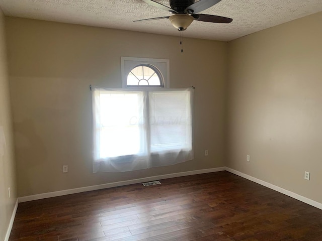 spare room featuring a textured ceiling, dark hardwood / wood-style flooring, and ceiling fan