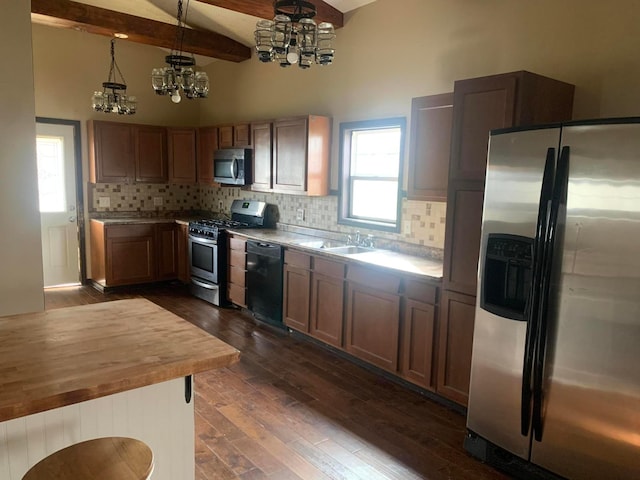 kitchen featuring dark wood-type flooring, an inviting chandelier, hanging light fixtures, a healthy amount of sunlight, and stainless steel appliances