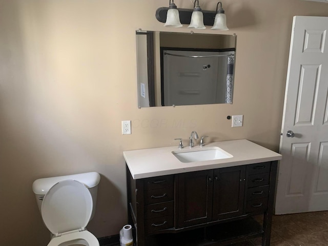 bathroom with vanity, toilet, and walk in shower